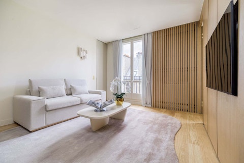 Settle into a light-filled Parisian living room with views