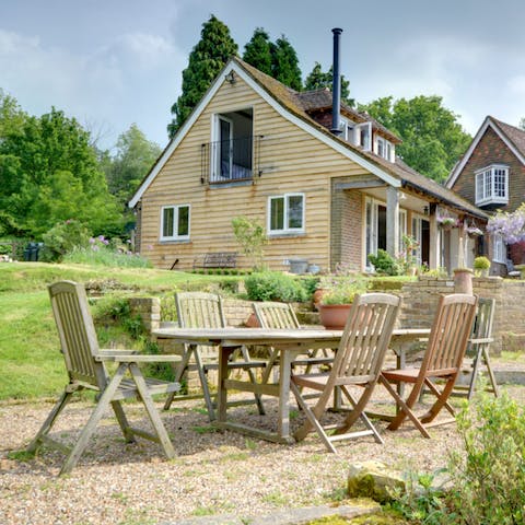 Dine alfresco besides bee-friendly flowers and wisteria blossom
