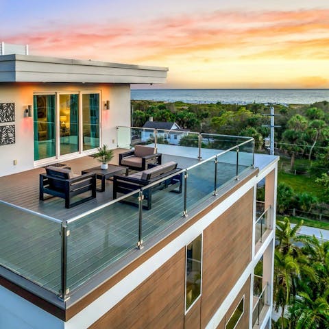 Watch the sun set over the sea from the rooftop balcony