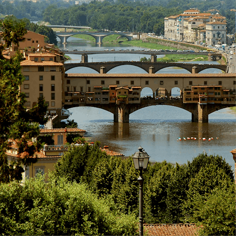 Stroll across Ponte Vecchio, shopping in the small boutiques lining each side