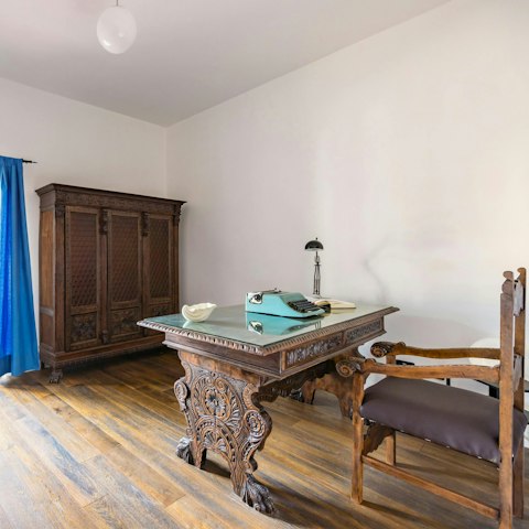 Catch up on work at the antique table and desk