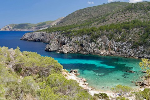 Discover Ibiza's stunning secluded coves with turquoise Mediterranean waters