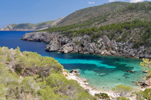 Discover Ibiza's stunning secluded coves with turquoise Mediterranean waters