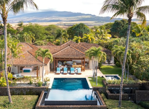 Cool off in the pool framed by palms and volcano views