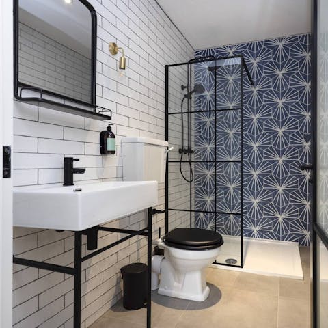 Start mornings off with a relaxing soak under the tiled bathroom's rainfall shower