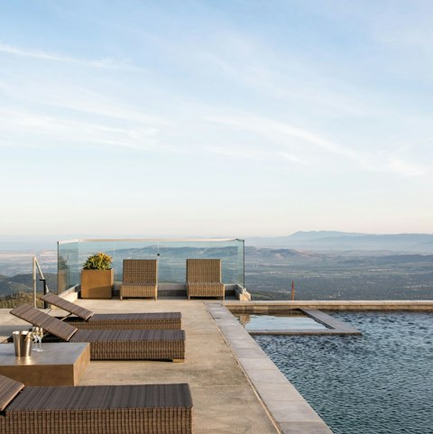 Stretch out beside the pool as valley views unfold below