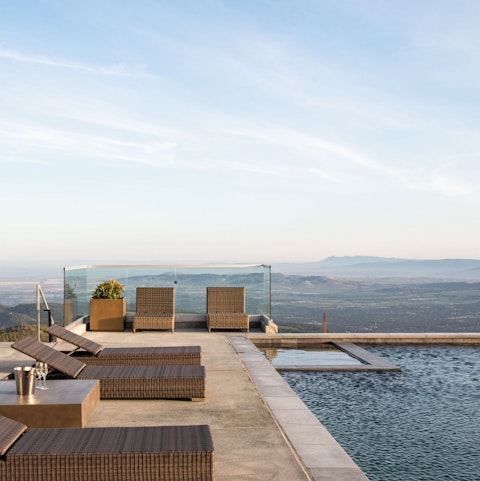 Stretch out beside the pool as valley views unfold below