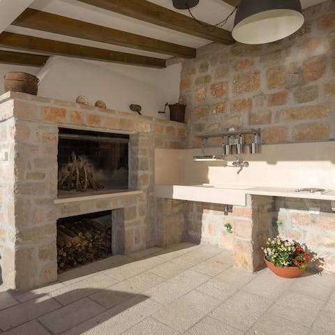 Try your hand at cooking cevapcici on the stone barbecue