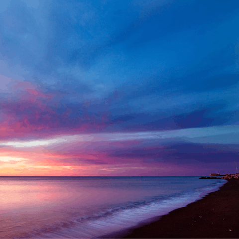 Watch the fiery sunset from Playa de Huelin