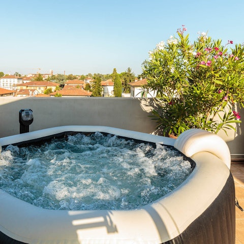 Enjoy a soak in the private hot tub as the sun goes down, admiring the scenery