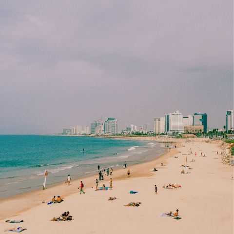 Sink your toes in the sand at Frishman Beach, eleven minutes away on foot