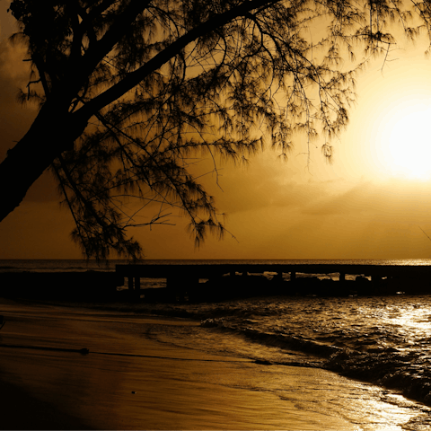 Step onto the sandy beach and watch the sunset