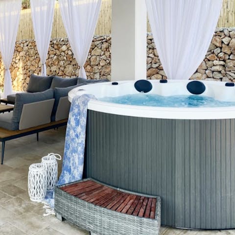 Sip a cold drink as you wind down in the bubbles of the hot tub