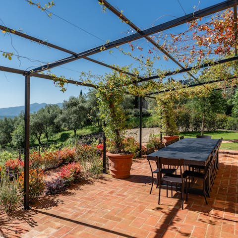 Dine alfresco, with views across the Tuscan countryside