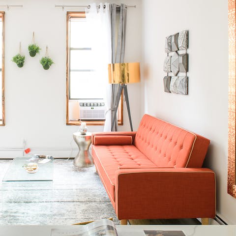 Put your feet up on the tomato red sofa after a day of exploring