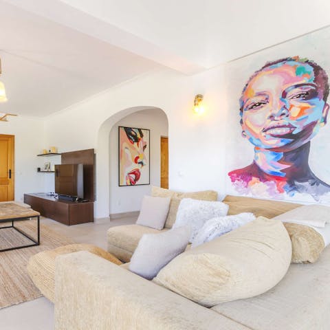 Sink into the comfortable couch, surrounded by beautiful artwork and good company