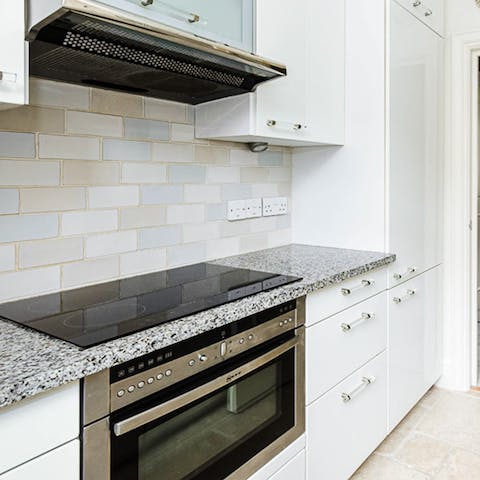 Cook up some bangers and mash in the sleek kitchen