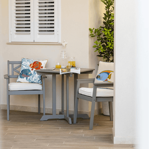 Rest with a good book and a glass of OJ on your trendy outdoor sitting area