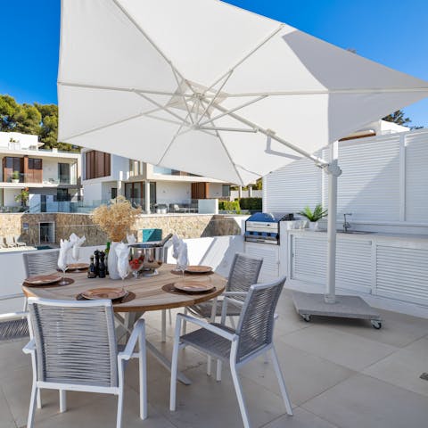 Dig into alfresco seafood paella on the rooftop terrace