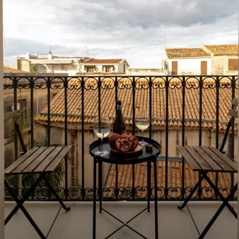 Enjoy a glass of Nero d'Avola on your balcony