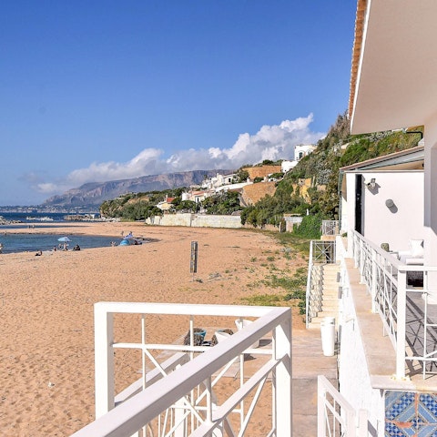 Experience kiteboarding and windsurfing at Trappeto Beach, just footsteps away