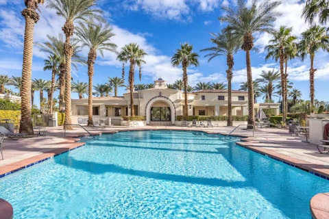 Cool off in the shared pool beneath swaying palm trees