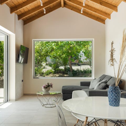 Sit beneath wood beams as the large windows frame the leafy scenery
