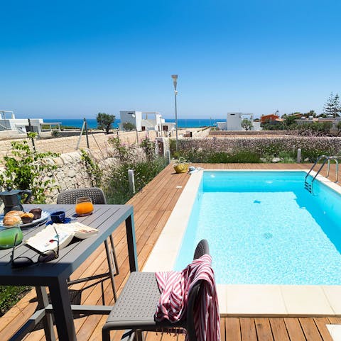 Tuck into breakfast and a good read with the pool as your backdrop