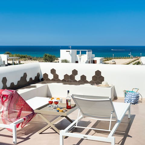 Enjoy a romantic Aperol Spritz on the master bedroom's private balcony