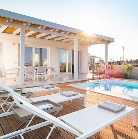 Lounge in peace next to the pool until the sun starts to set
