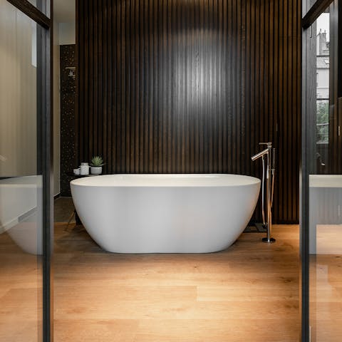 Soak in the sleek bathtub in the main en-suite