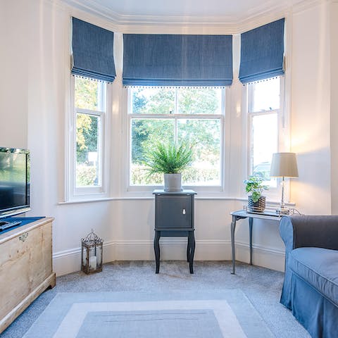 Relax in the bright living room with traditional bay window