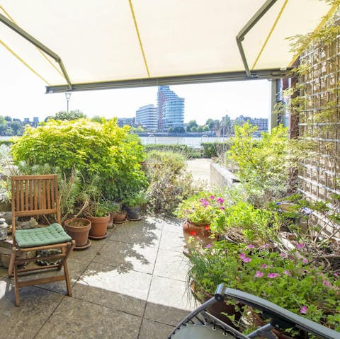 Enjoy a glass of wine in the pretty plant-filled patio garden