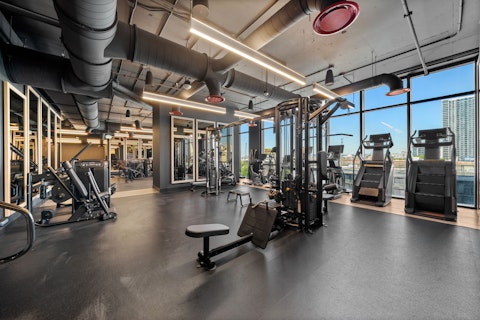Train with full gym equipment framed by sweeping city views