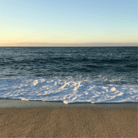 Watch the waves crashing against the shore at Fonte da Telha