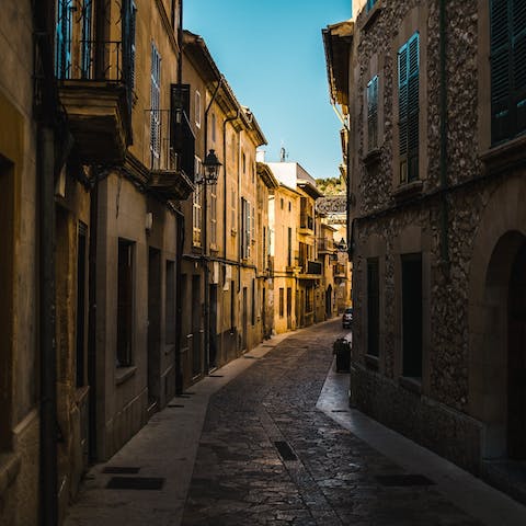 Stroll the romantic, cobbled streets of Pollença – a thirteen-minute drive away