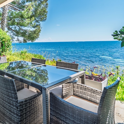 Dine alfresco on the private terrace overlooking the sea