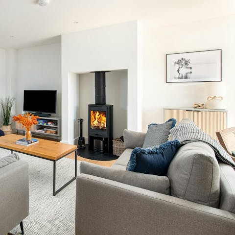 Curl up on the sofa with a good book and a comforting fire crackling in the background