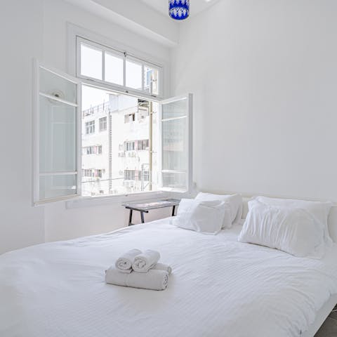 Wake up with the Israeli sunshine in this serene master bedroom