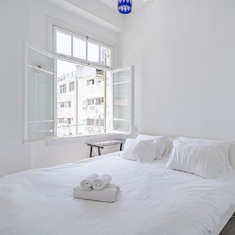 Wake up with the Israeli sunshine in this serene master bedroom