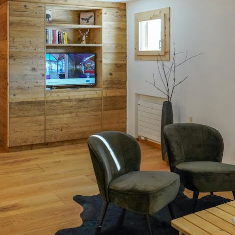 Get cosy in the wood-panelled living area