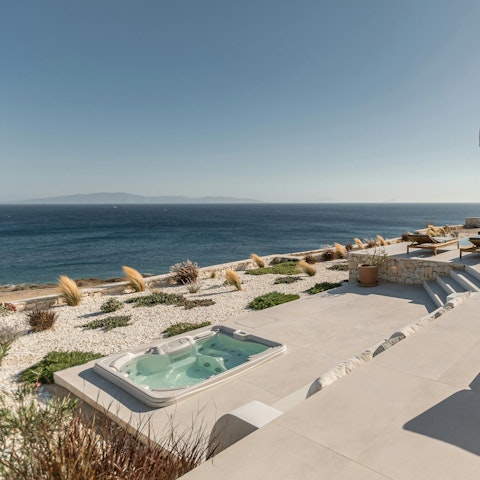 Enjoy dips in the hot tub with a cocktail and a sea view