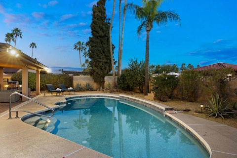 Cool off in the pool as palm trees frame the desert sky