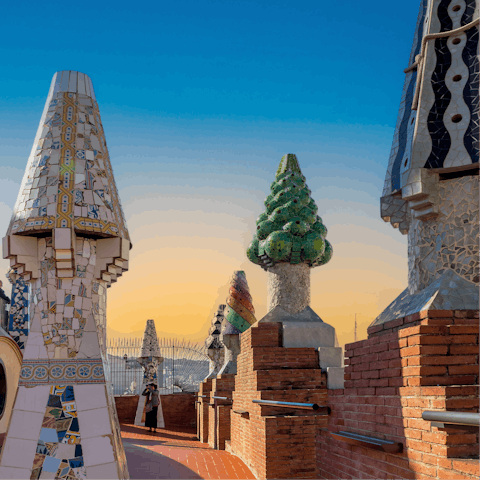 Visit the mosaic-covered sculptures at Park Güell, with exquisite views over the city