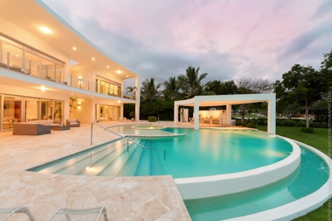 Swim laps as a pastel sky melts over the palms