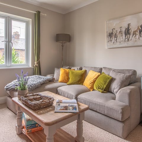 Relax in the bright living room with a glass of wine after a day of exploring