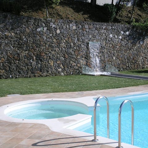 Swim in the private infinity pool with hot tub