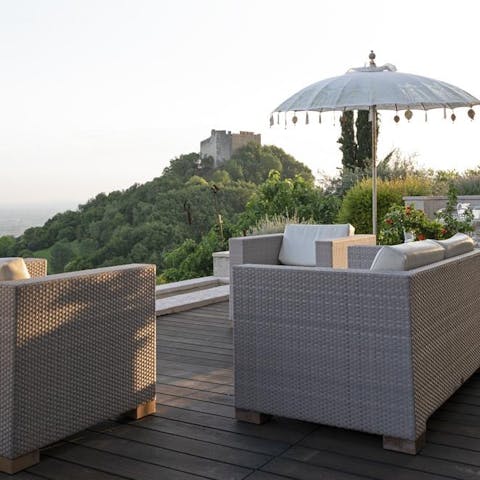 Watch the sun dip behind the trees from the comfy outdoor sofa