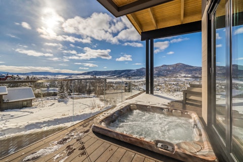 Soak in the bubbling tub above a snow-dusted valley