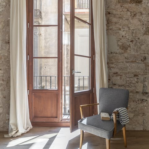 Relax with a novel on the armchair next to your balconette